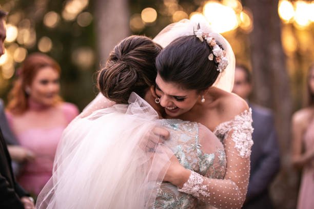 Bride and her mother hugging each other at the wedding venue.
