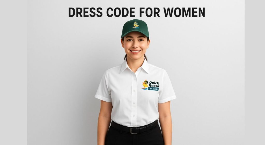 Female Quick Quack Car Wash employee wearing the official dress code — white shirt, khaki pants, and non-slip black shoes — standing confidently outside the car wash facility.